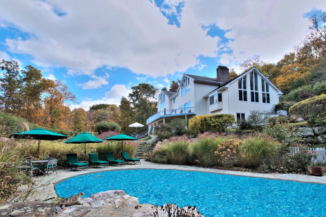 Experience dramatic, modern living in this grand home with a glorious gunite pool exceptional architectural appeal.