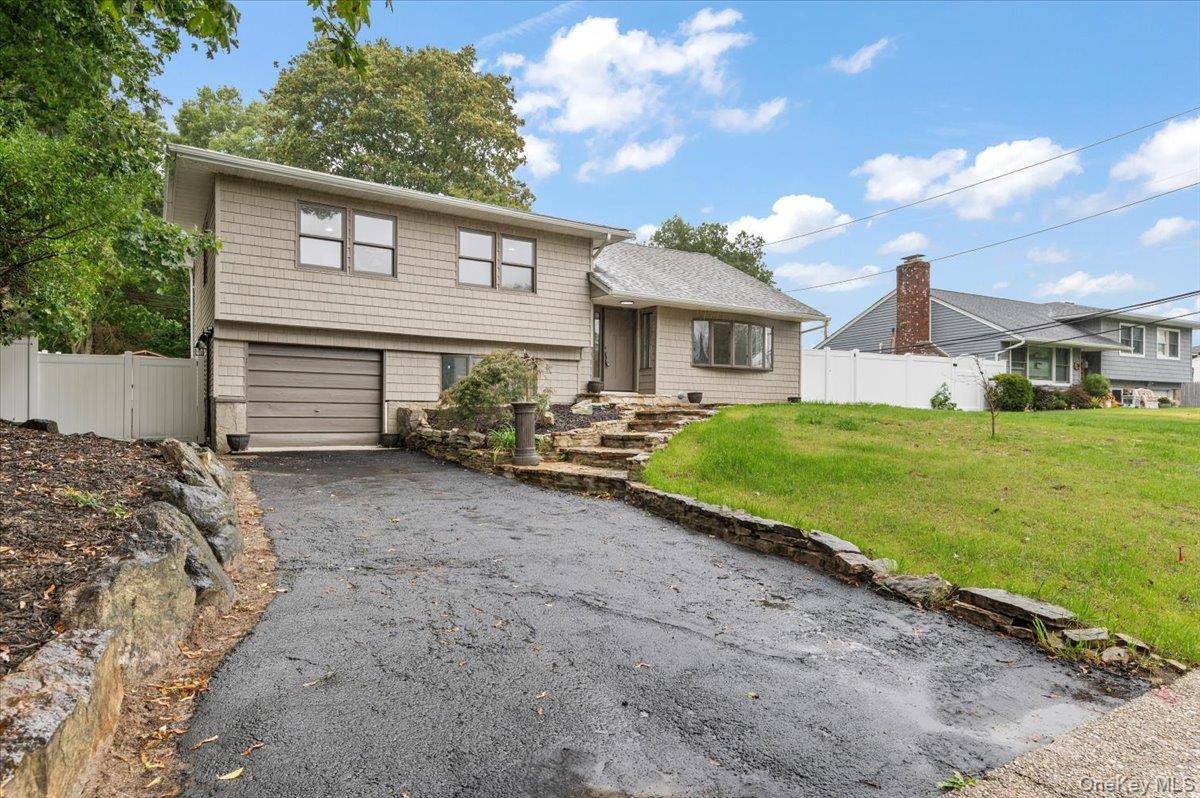Welcome to 6 Nowick Lane, nestled in the desirable Legend Woods community of Smithtown.
