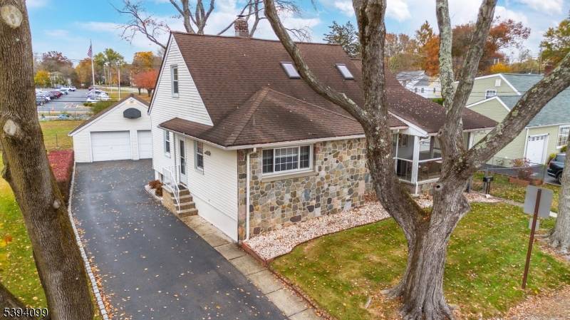Warm and inviting this charming Cape Cod style home featuring a stone front a screened in front porch with beautiful flagstone slate flooring.
