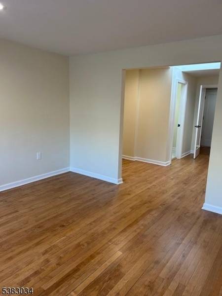 Approximately 425 sq ft of professional office space with large windows providing natural light, hardwood floors, and a private restroom.