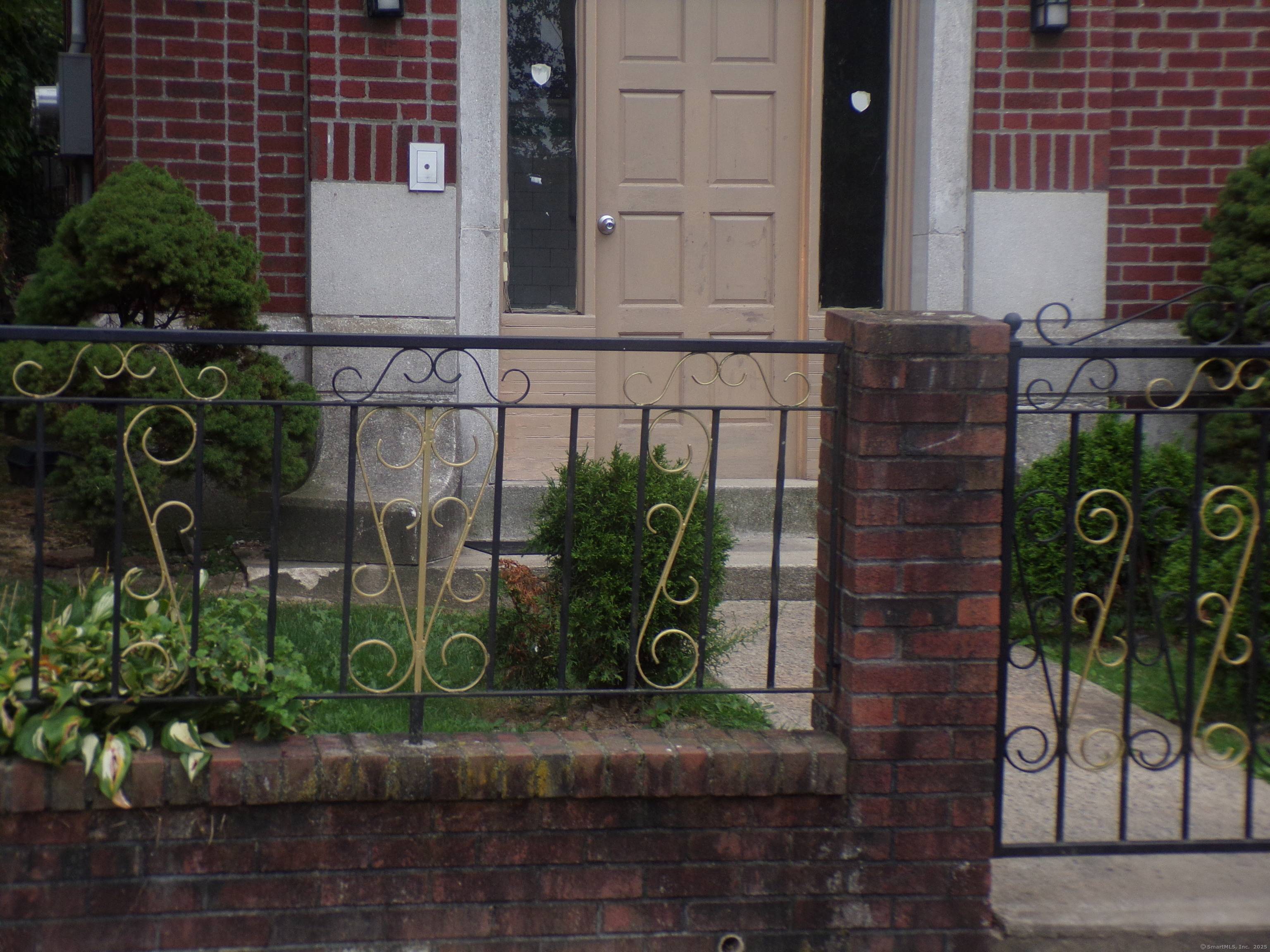 Well kept three family with brick exterior and two large car garages.