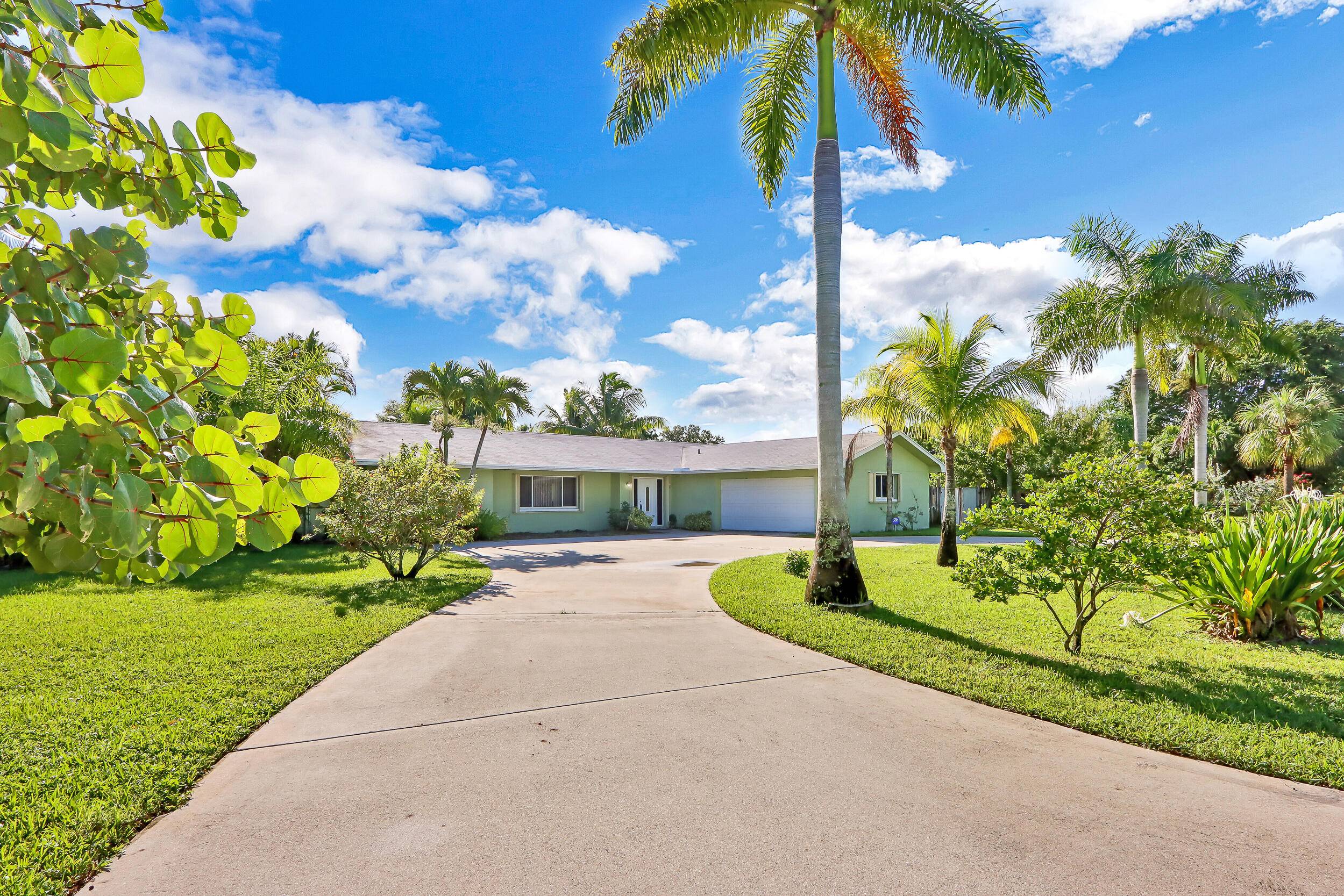 This spacious home combines privacy, comfort, and outdoor living on nearly an acre east of I 95.