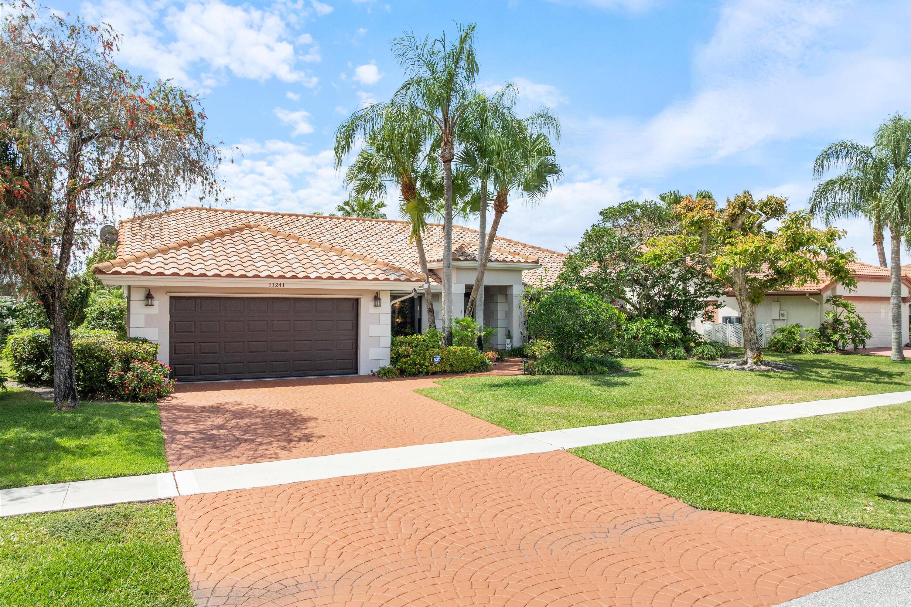 Serenity abounds in this west Boca Raton gated community rancher with a stunning wide lake view and inground pool !