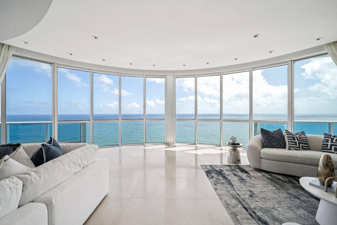 Unobstructed direct oceanfront penthouse commanding the entire southern wing of the building with sweeping coastline views.