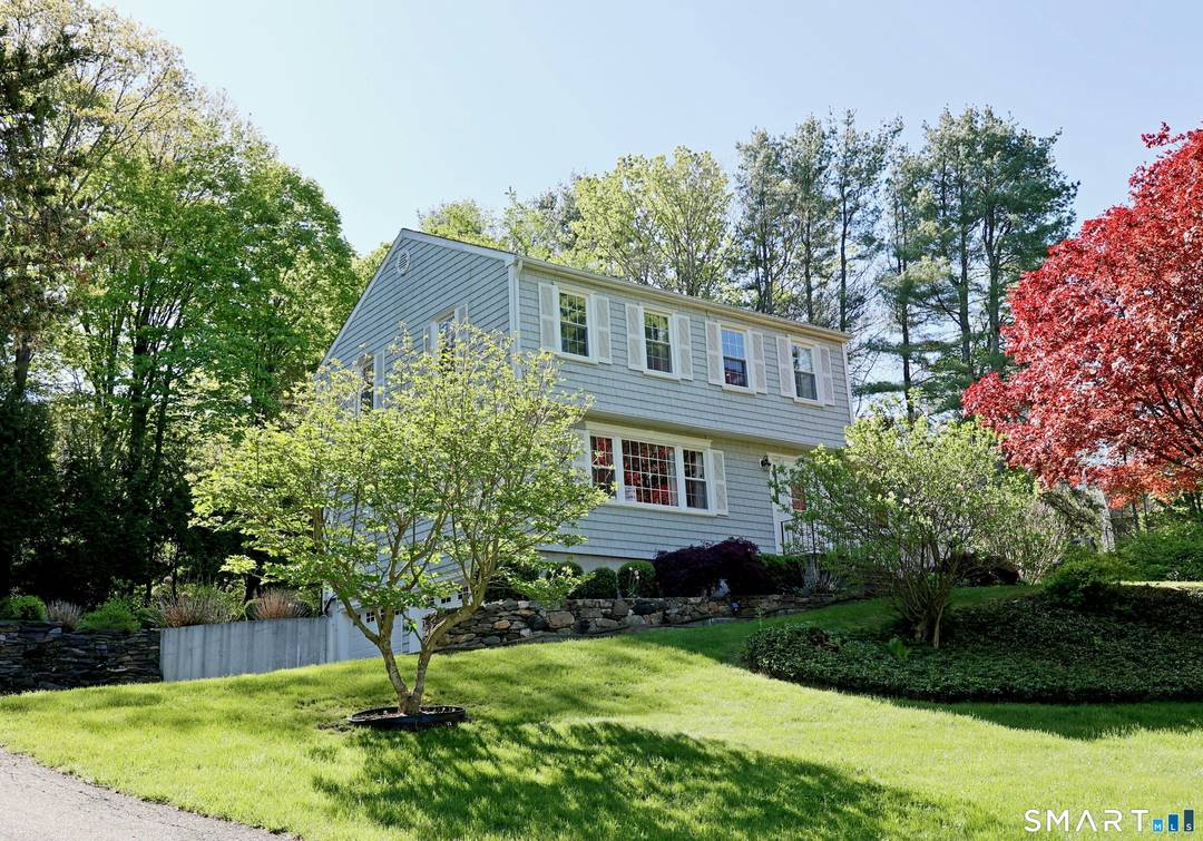 Picture perfect colonial at the end of a cul de sac on park like acre with stone walls, flowering gardens, and expansive deck for outdoor enjoyment.