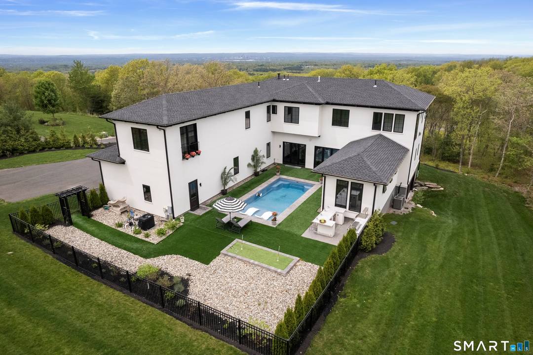Perched atop a scenic ridge in Glastonbury, this Mediterranean inspired estate offers breathtaking panoramic views, including the Connecticut State Capitol, with seamless indoor outdoor living.