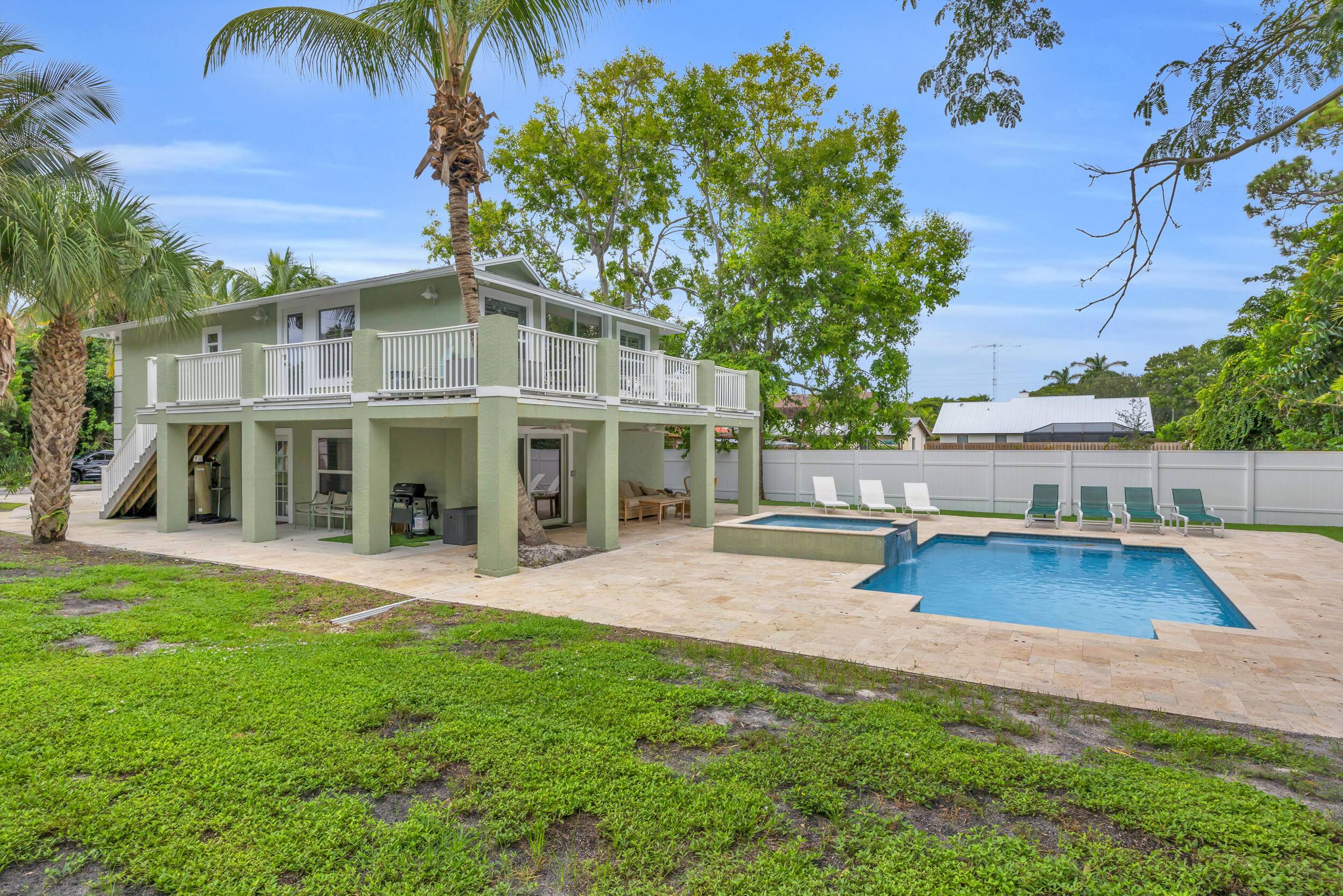 Welcome to this rare, private tropical retreat on a double lot, tucked among plush, exotic landscaping.