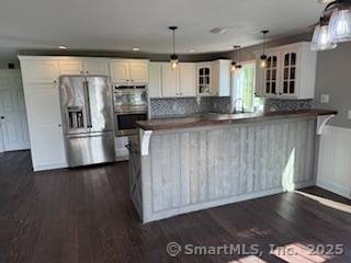 A Equestrian lovers delight a unique opportunity to own 32 acres complete with renovated colonial style home and 15 stall barn with second story finished loft.