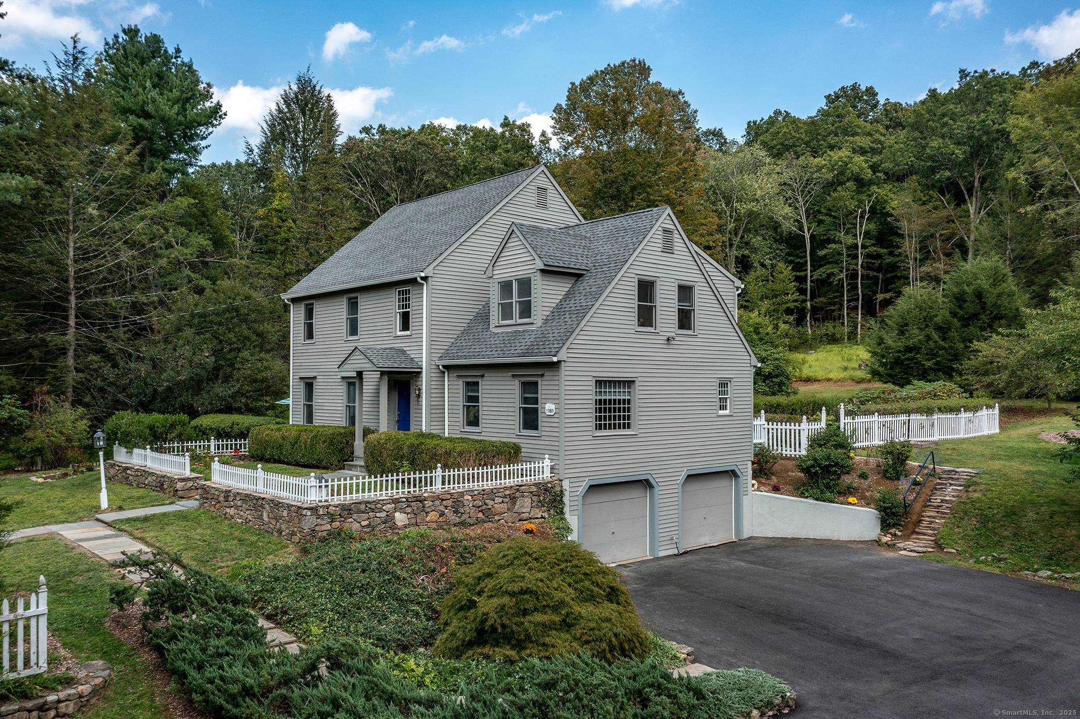 Quintessential Roxbury retreat, an updated classic 3 bedroom Colonial with open floor plan and separate office, nestled on over 4.