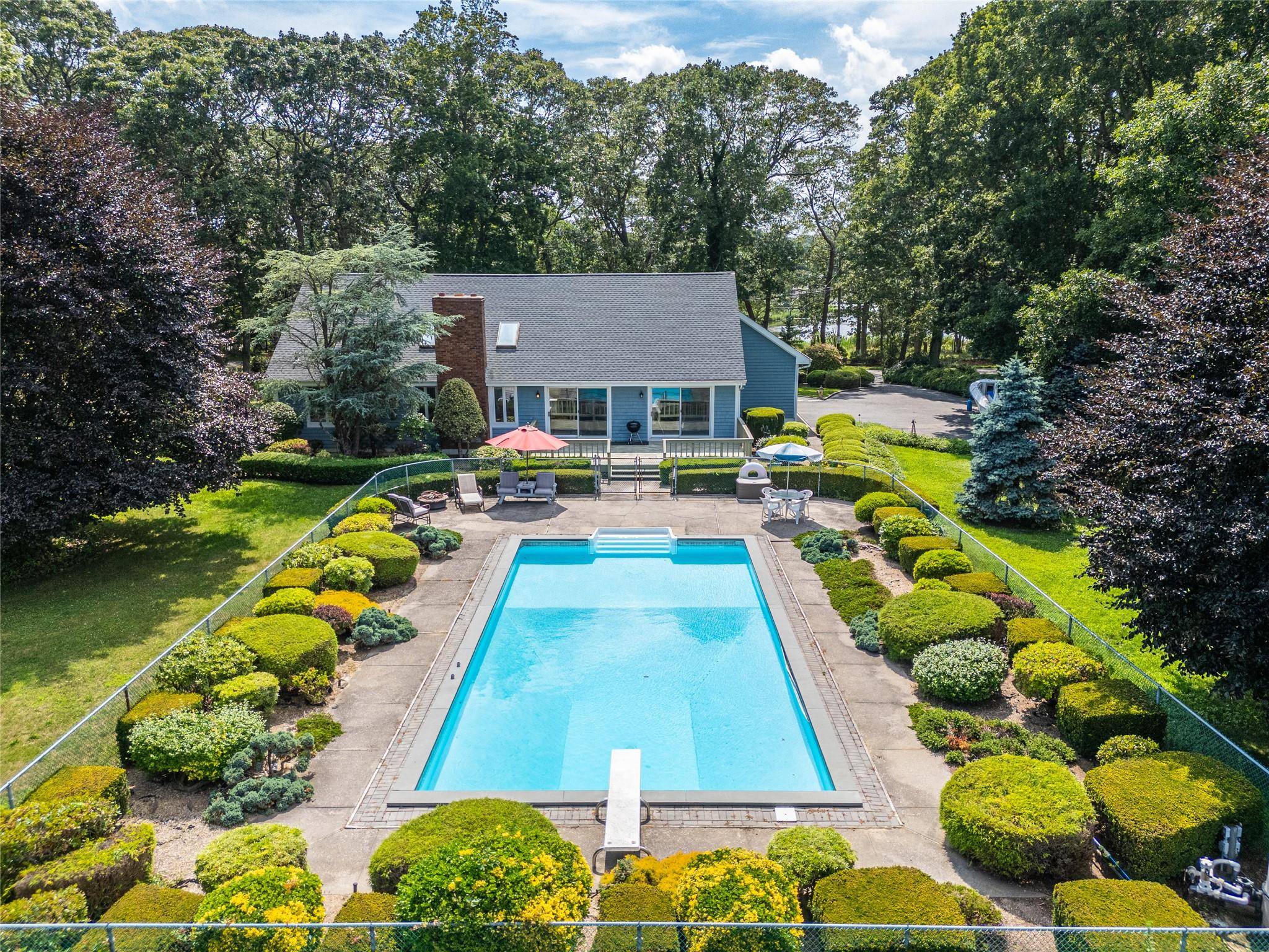 Welcome to 250 Peconic Bay Boulevard, a west facing haven nestled on over an acre of beautifully landscaped grounds, offering breathtaking views of Reeves Creek with awe inspiring sunsets.