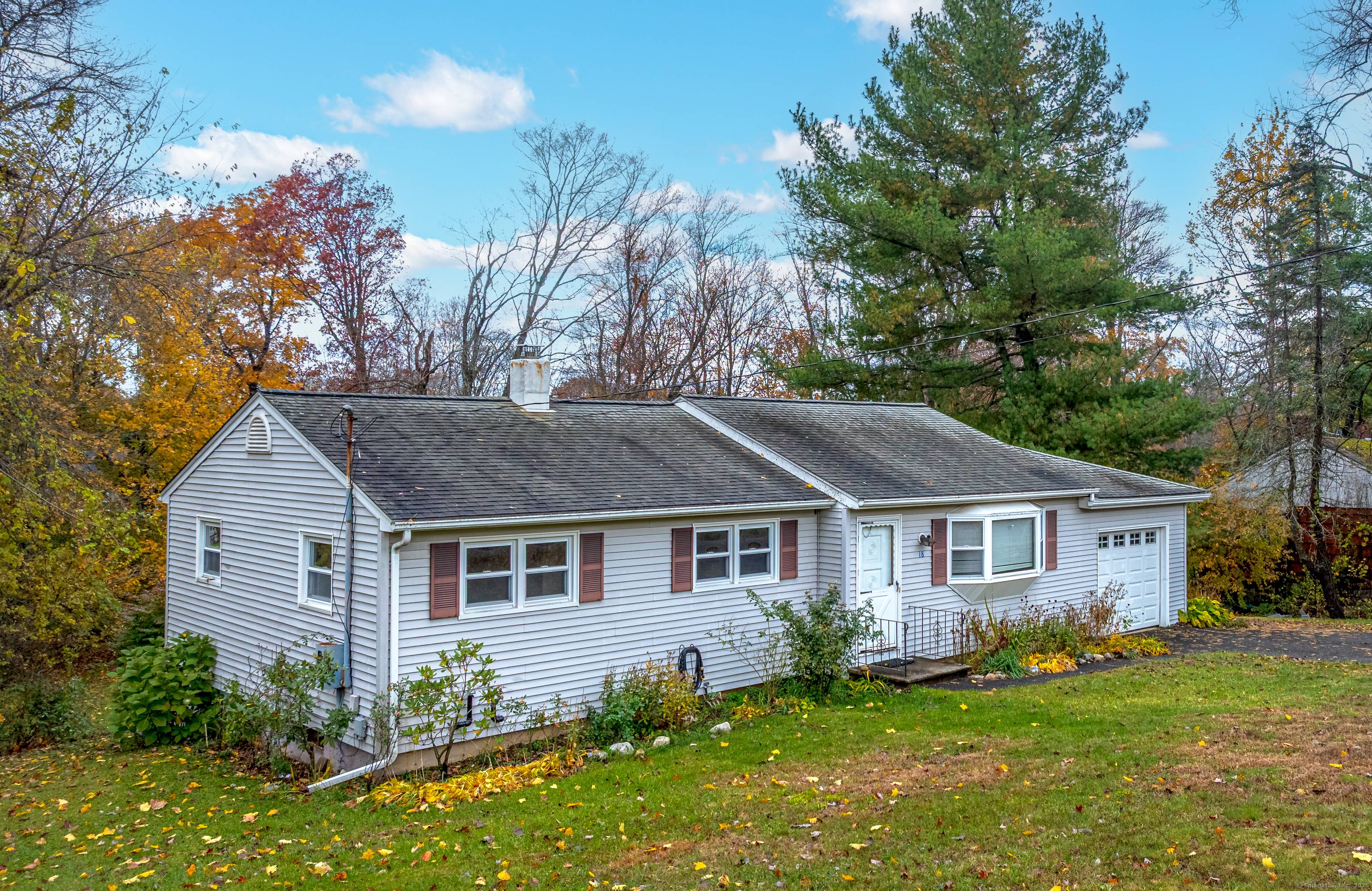 Charming Bethel 4 bedroom, 2 bathroom ranch home with a finished lower level and an attached garage set a.