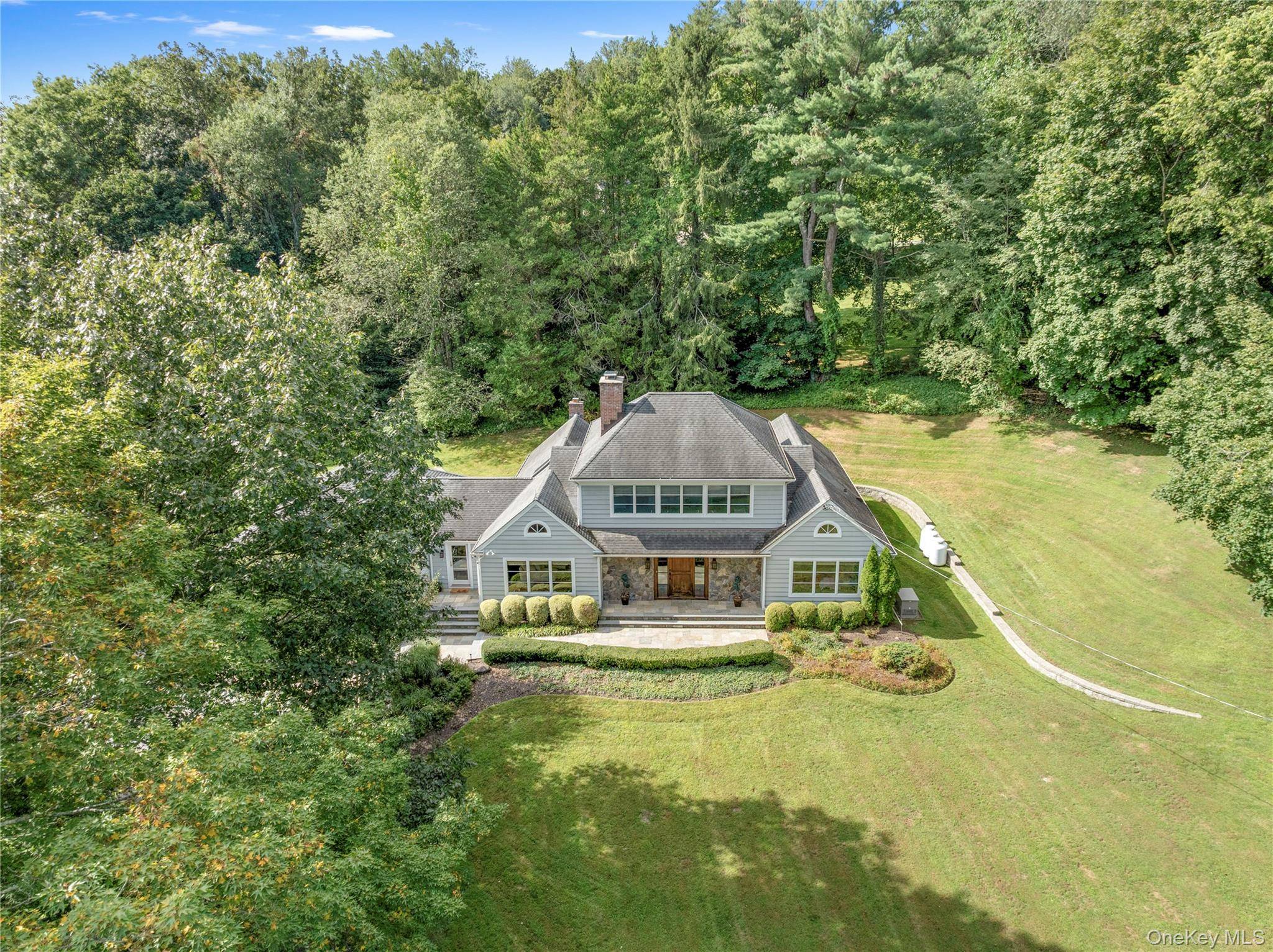 Welcome to 56 Annandale Drive, Chappaqua, a capacious and captivating Cape Cod commandingly set on 1.