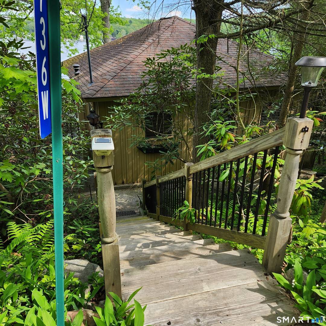 Welcome to WatersEdge a Seasonal Cottage perched on a landscaped hillside overlooking Third Bay of beautiful Highland Lake.