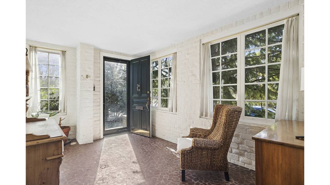 Rarely available, this beautifully renovated corner Atterbury tapestry brick townhouse exemplifies the timeless elegance and craftsmanship that define Forest Hills Gardens, seamlessly blending historic character with sophisticated modern updates.