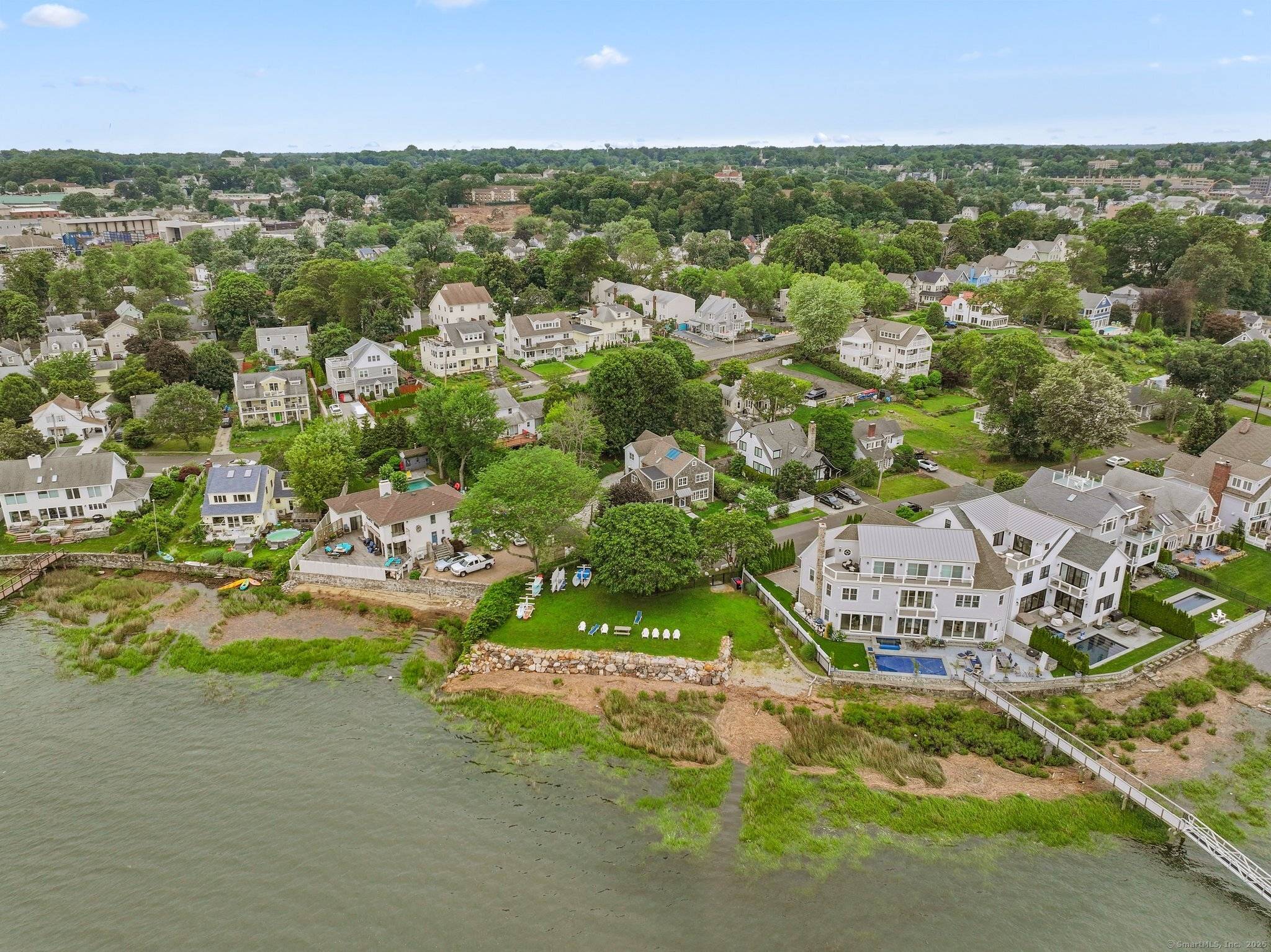 Welcome to Oyster Bend a fitting name for this remarkable waterside retreat offering panoramic views of Long Island and just steps to the water and kayak park.
