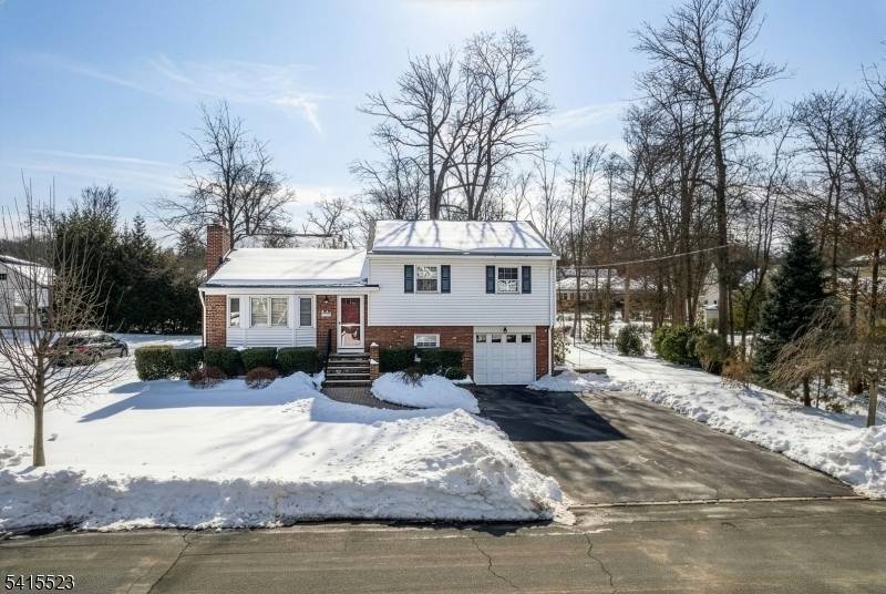 Located in a sought after neighborhood, this beautifully maintained home has impressive curb appeal with manicured shrubbery and a welcoming paver walkway leading to the entry.