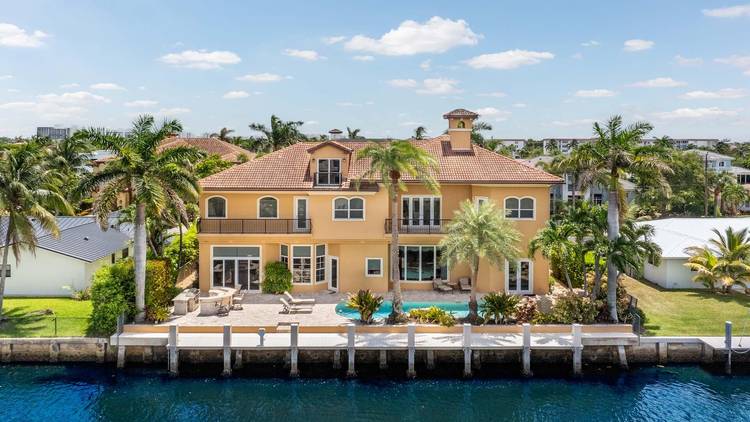 Welcome to 929 Banyan Drive, a home that blends timeless craftsmanship with the ease of waterfront living.