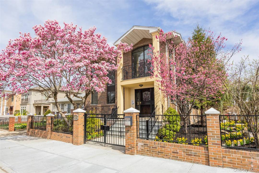 Welcome to this stunning, all brick legal two family corner home, rebuilt in 2013 and nestled in the heart of Flushing.