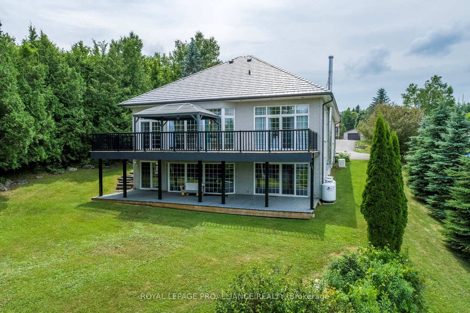 Welcome to Buckhorn Lake Estates where you'll find a handsome light filled all brick custom bungalow, perfectly situated in the desirable Kawartha Lakes.