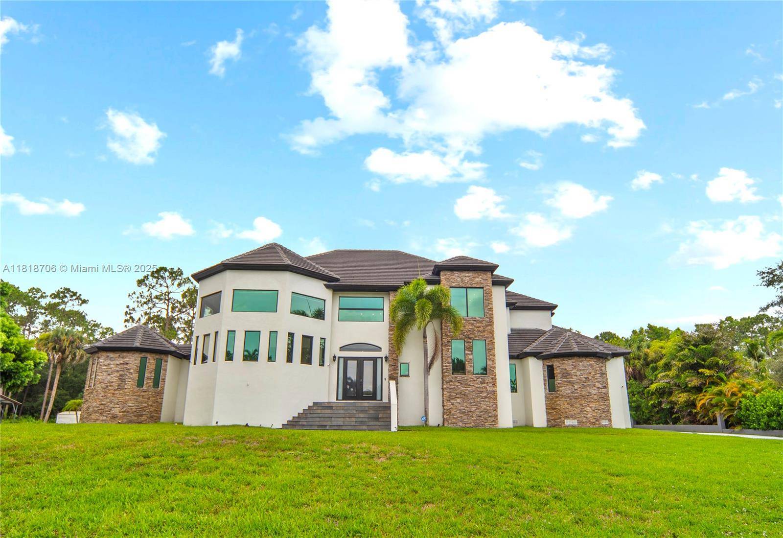 Discover one of the largest and most captivating homes in Jupiter Farms, offering over 6, 000 sq ft on a lush 1.