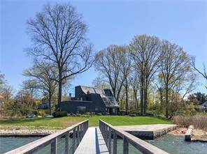 One of a kind, updated contemporary with magnificent water views from almost every room in the house.