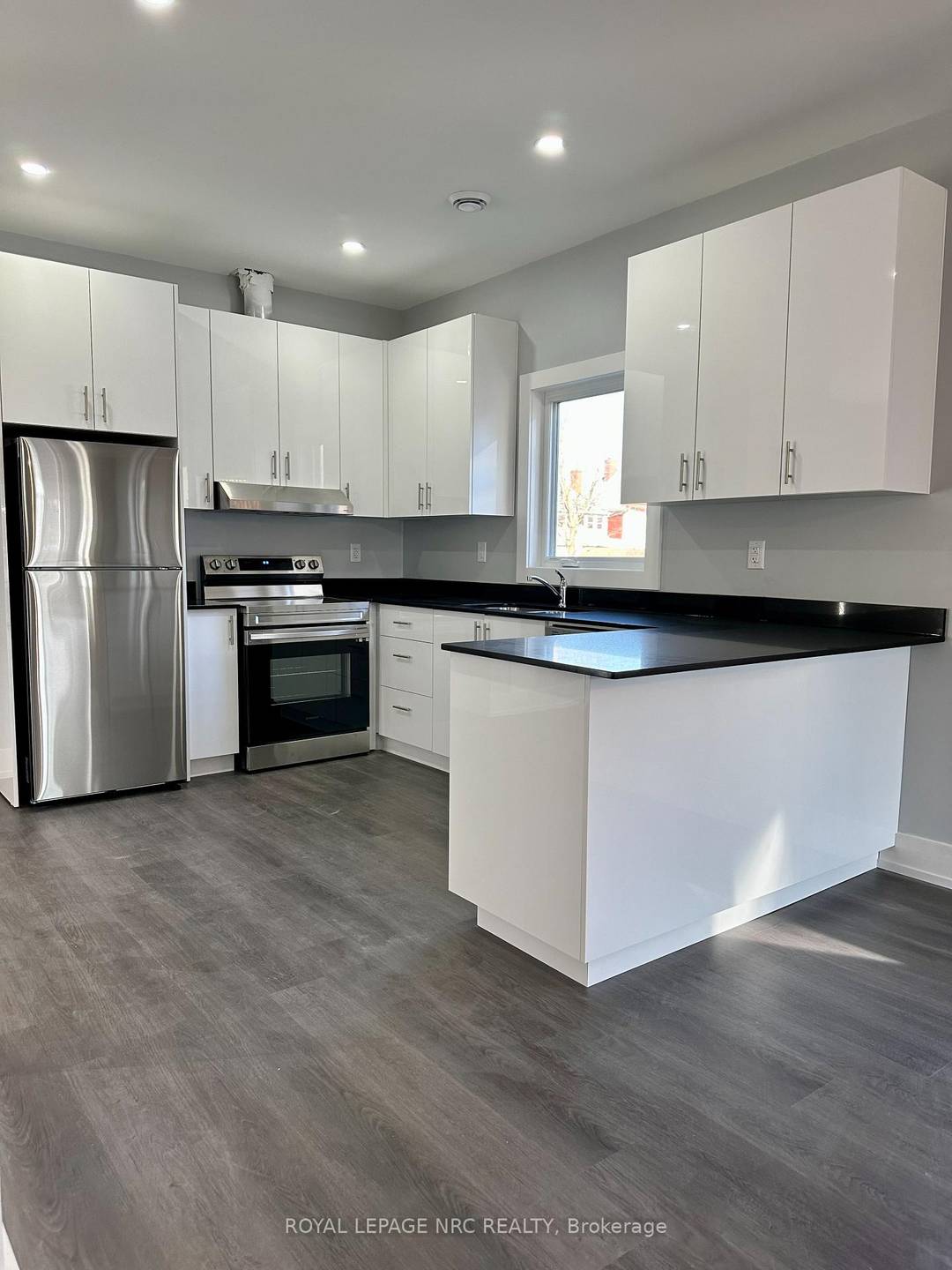 New, large duplex. Upper unit has 3 large bedrooms plus den, large open concept kitchen, dining room and living room.