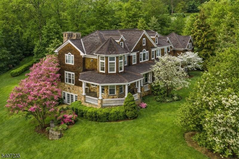 This Mark built Hampton inspired residence reflects timeless architecture and exceptional craftsmanship, introduced by a classic covered porch and a dramatic 20 foot foyer.
