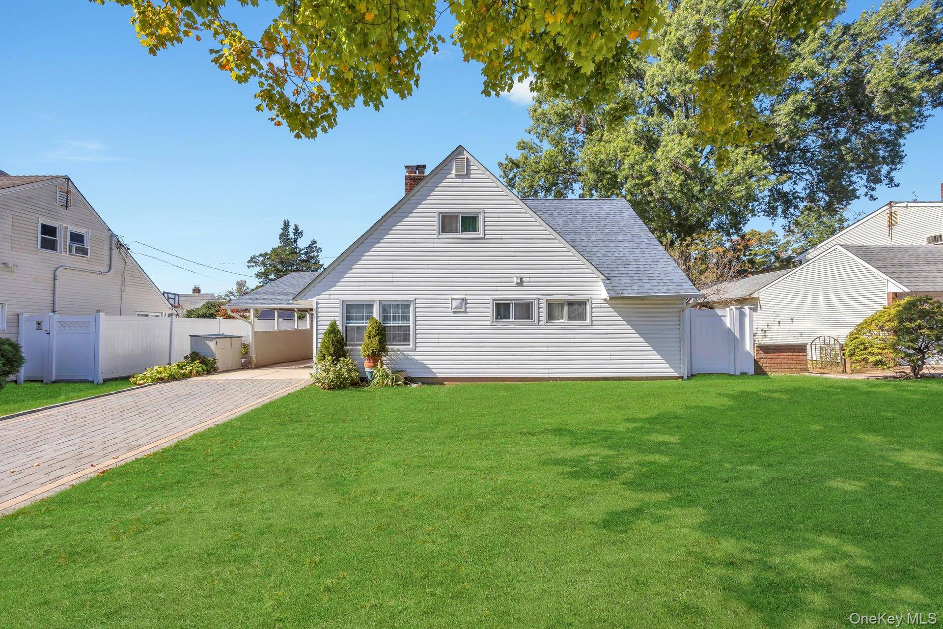 Welcome to this well maintained Cape in Hicksville !