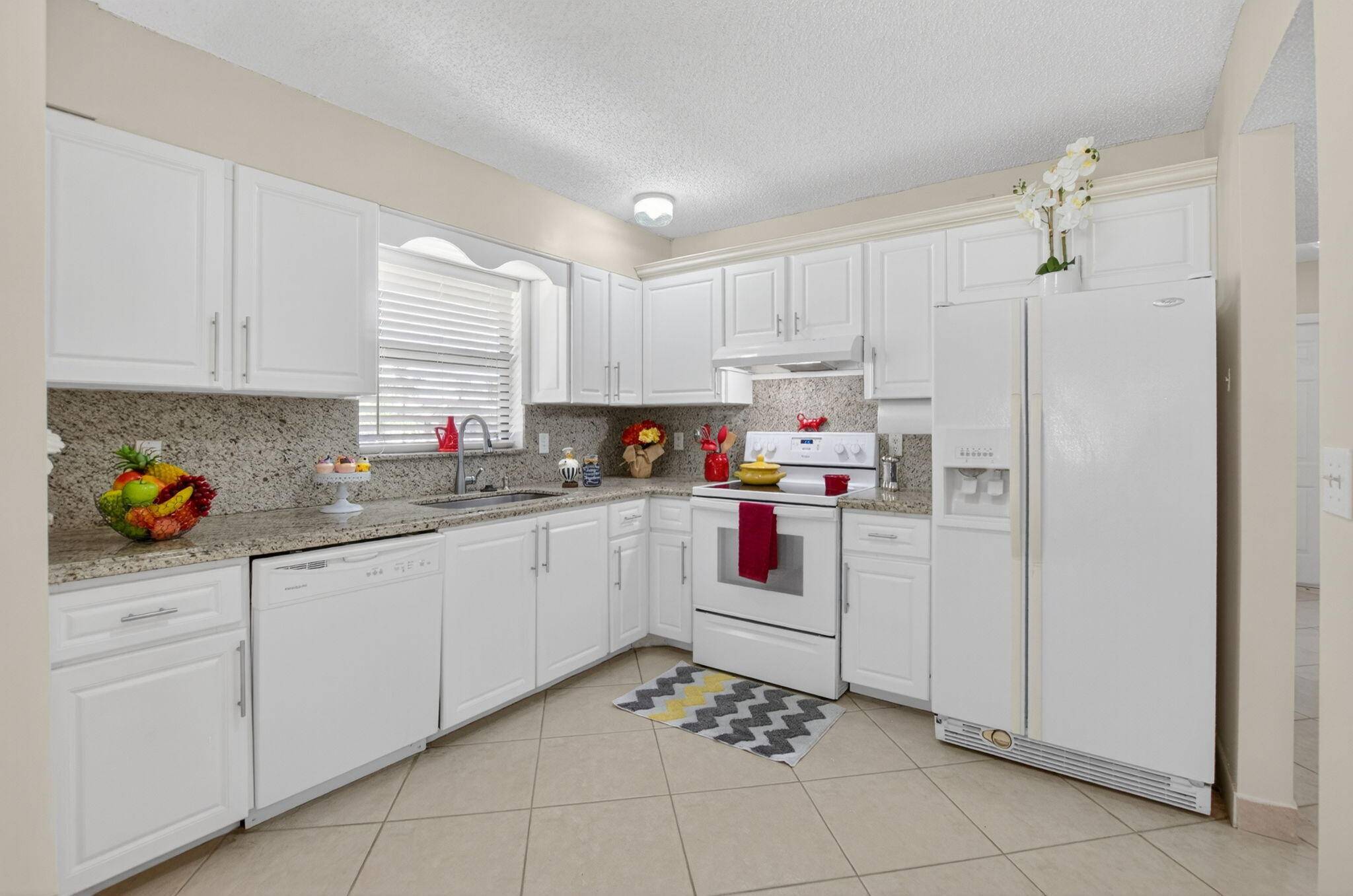 Experience serene living in this rarely available, second floor condo within the tranquil, gated Boca Cove community.