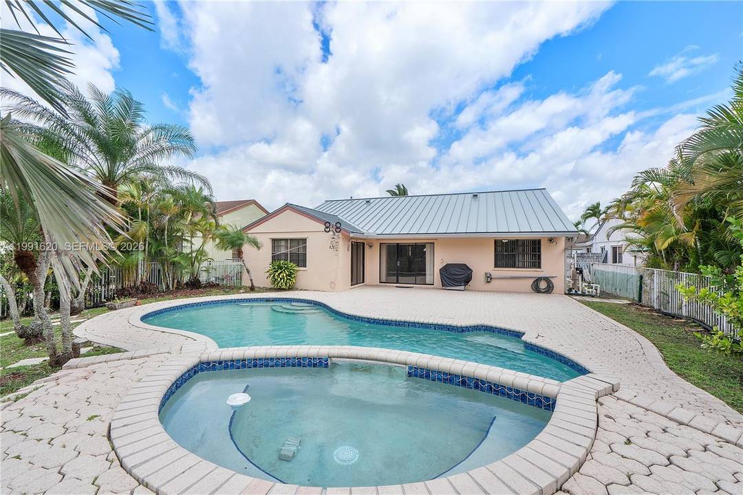 Beautifully maintained home with serene water views and a private backyard oasis featuring a POOL and SPA, perfectly designed for Florida living !