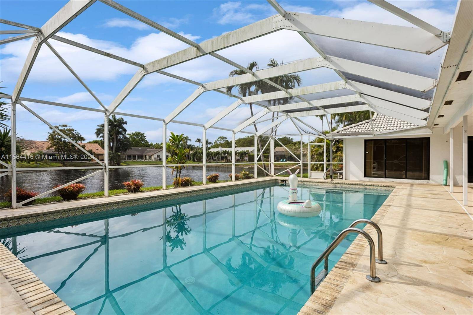 Enjoy the epitome of South Florida living in this stunning property featuring an expansive outdoor area with a super sized screen enclosed pool 20 ft X 40 ft in a ...