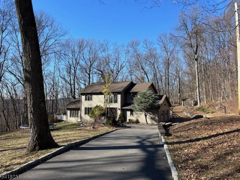 Nestled on a private, wooded lot, this beautiful custom home offers space, comfort and style throughout.