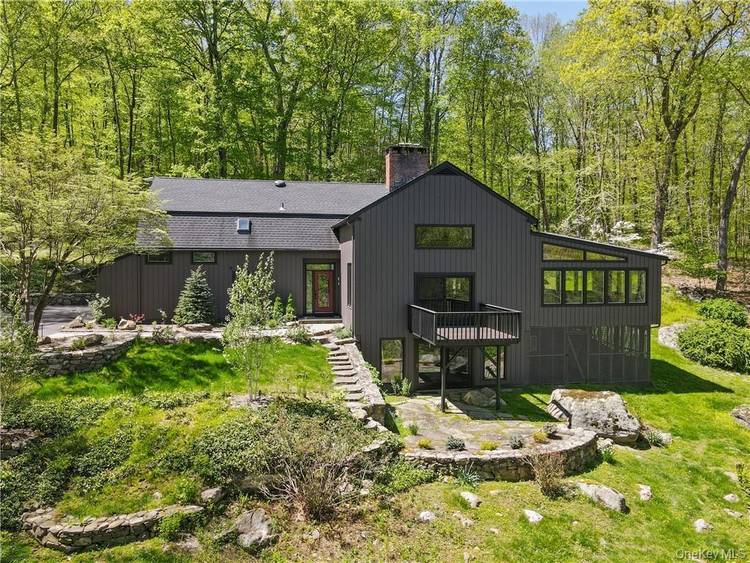 Stunning Contemporary Farmhouse in Pound Ridge, NY set on over 3 acres of secluded woodland, this exceptional three bedroom home blends modern elegance with timeless rustic character.