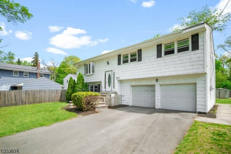 Welcome to 911 Plainfield Ave, a spacious 4 bedroom, 2 full bathroom split level home located in the desirable Van Wyck Brooks section of Queen City.