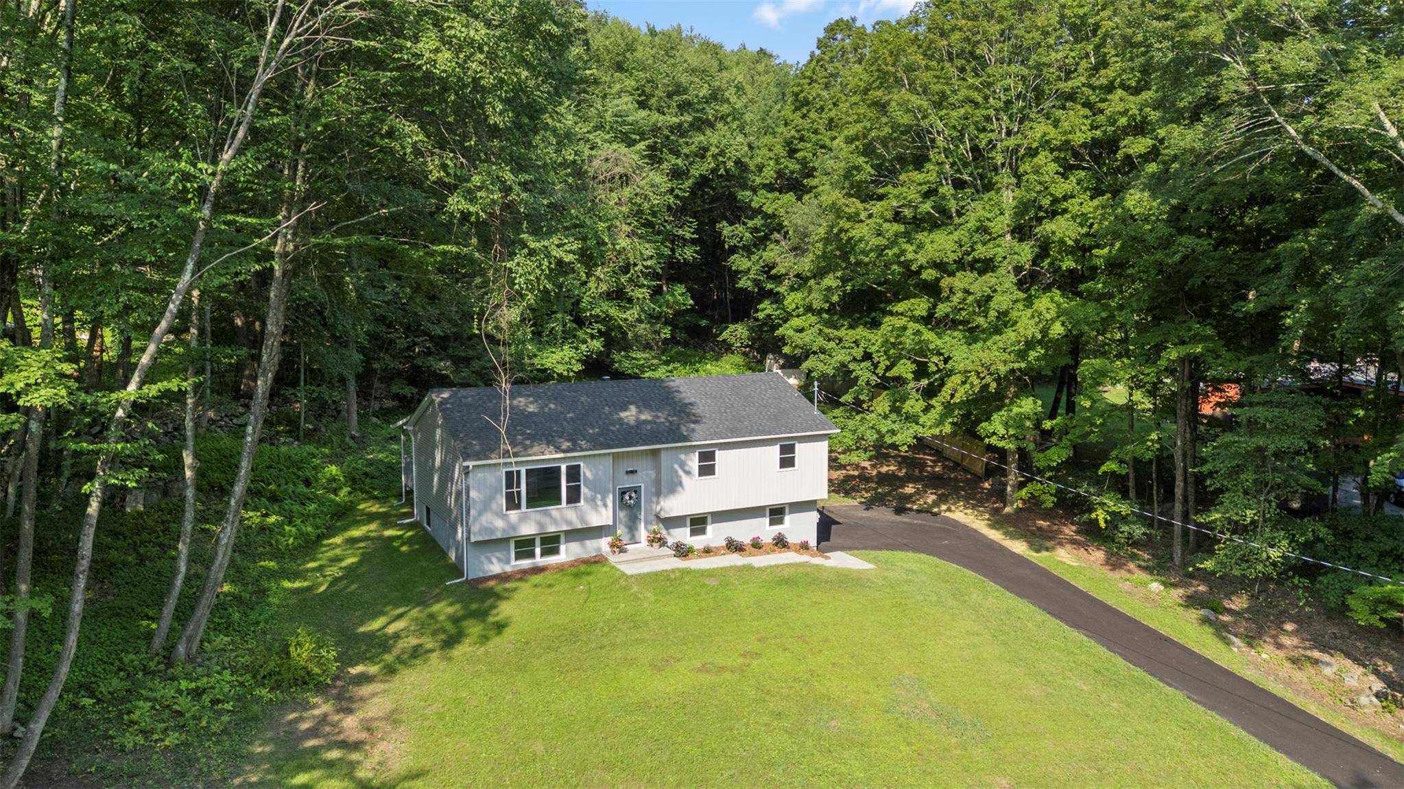 Amidst nature, surrounded by lakes, mountains, and the Appalachian Trail, this beautifully renovated raised ranch sits on a sprawling 1.