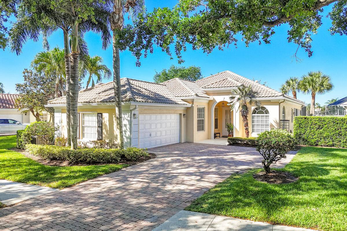 Welcome to 1319 Saint Lawrence Drive, Palm Beach Gardens, where breathtaking long lake views set the stage for luxurious living.