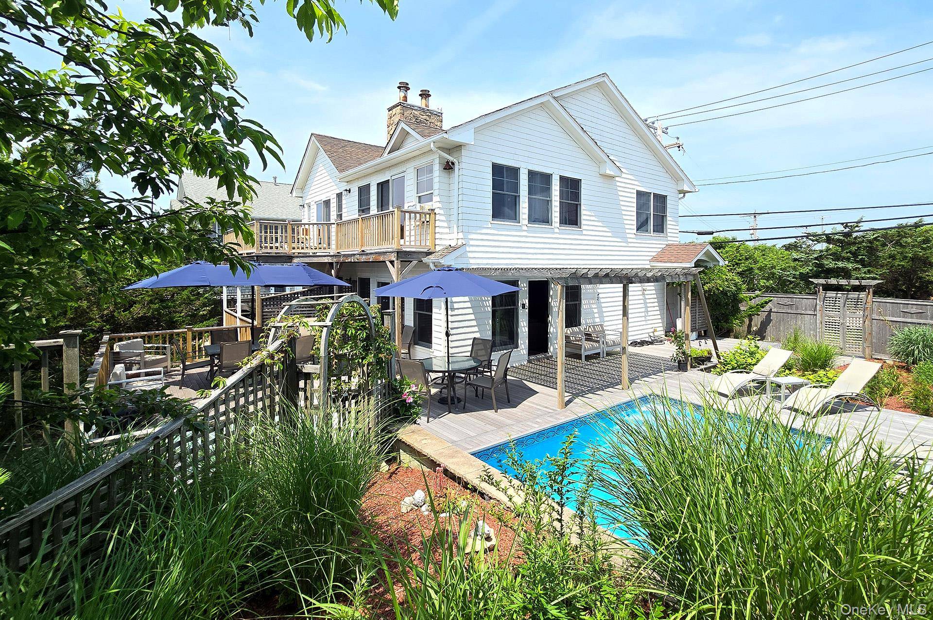 Coveted Oceanfront Classic Easy Access from NYC Turnkey Relaxed Luxury with Heated Pool Welcome to your dream retreat a timeless beachfront oasis blending classic coastal charm with modern sophistication.
