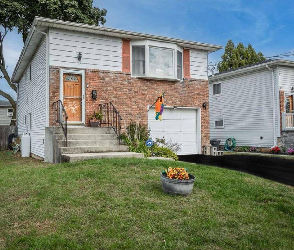 Welcome to this beautifully maintained 4 bedroom, 2 bathroom High Ranch nestled in the heart of West Babylon.