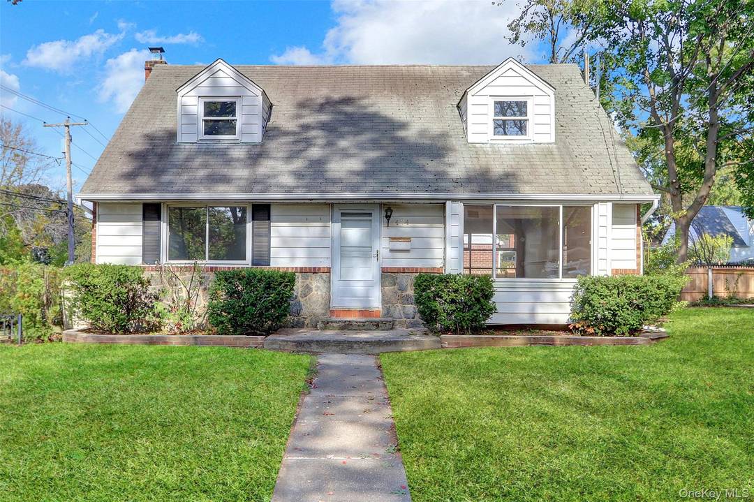 Cape Cod style Home. This home features four bedrooms, 2 full baths, a formal dining room, and an eat in kitchen.