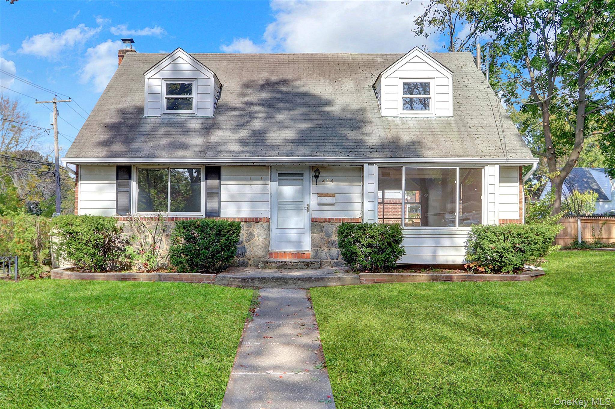 Cape Cod style Home. This home features four bedrooms, 2 full baths, a formal dining room, and an eat in kitchen.