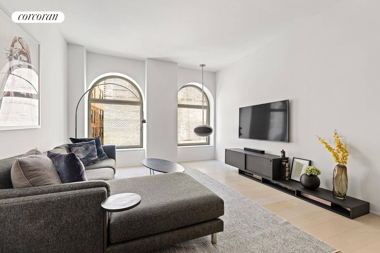 Welcome to Residence 14D, a meticulously crafted two bedroom, two bathroom home offering soaring 10 foot ceilings and iconic arched bronze detailed windows that flood the space with natural light.