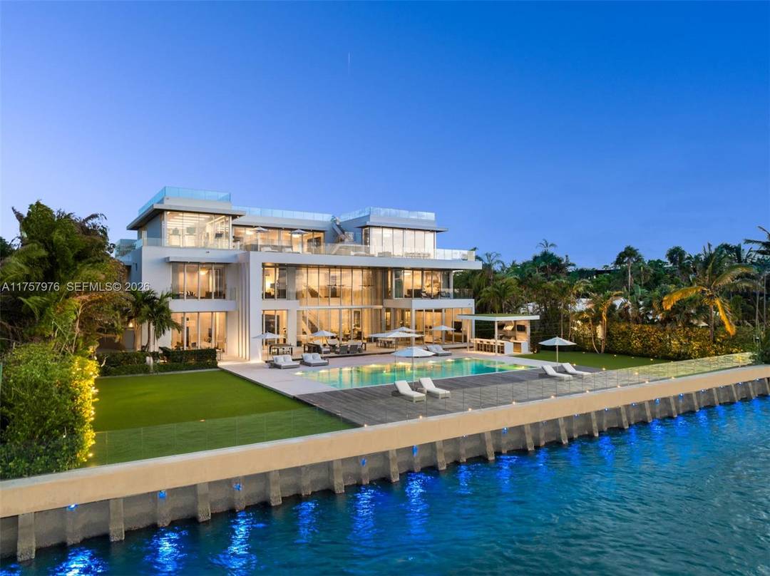 True trophy estate, this custom built masterpiece spans 4 levels, 21, 927SF of curated living spaces, redefining luxury waterfront living in Bal Harbour.