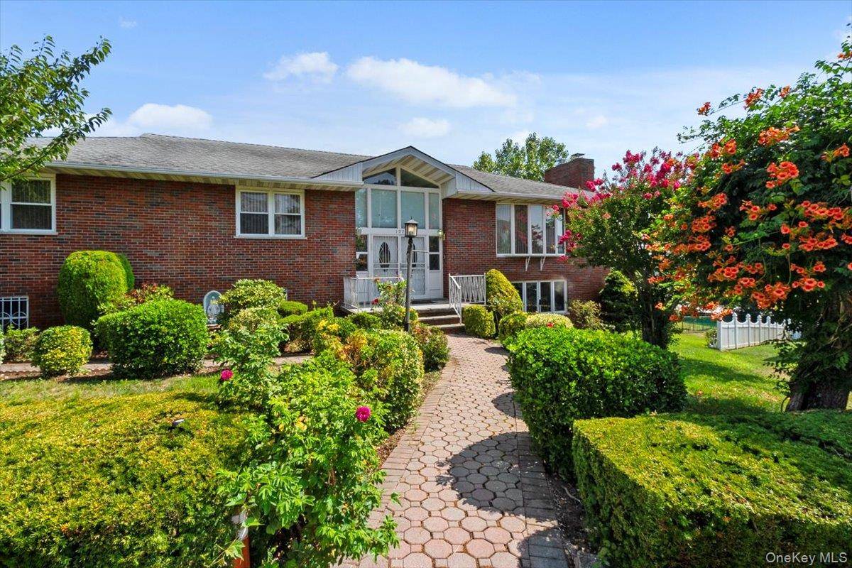 HOME is this beautiful 4 bedroom brick Raised Ranch in the sought after Hearthstone area of Yonkers, offering exceptional space and flexible living options for large or extended families.