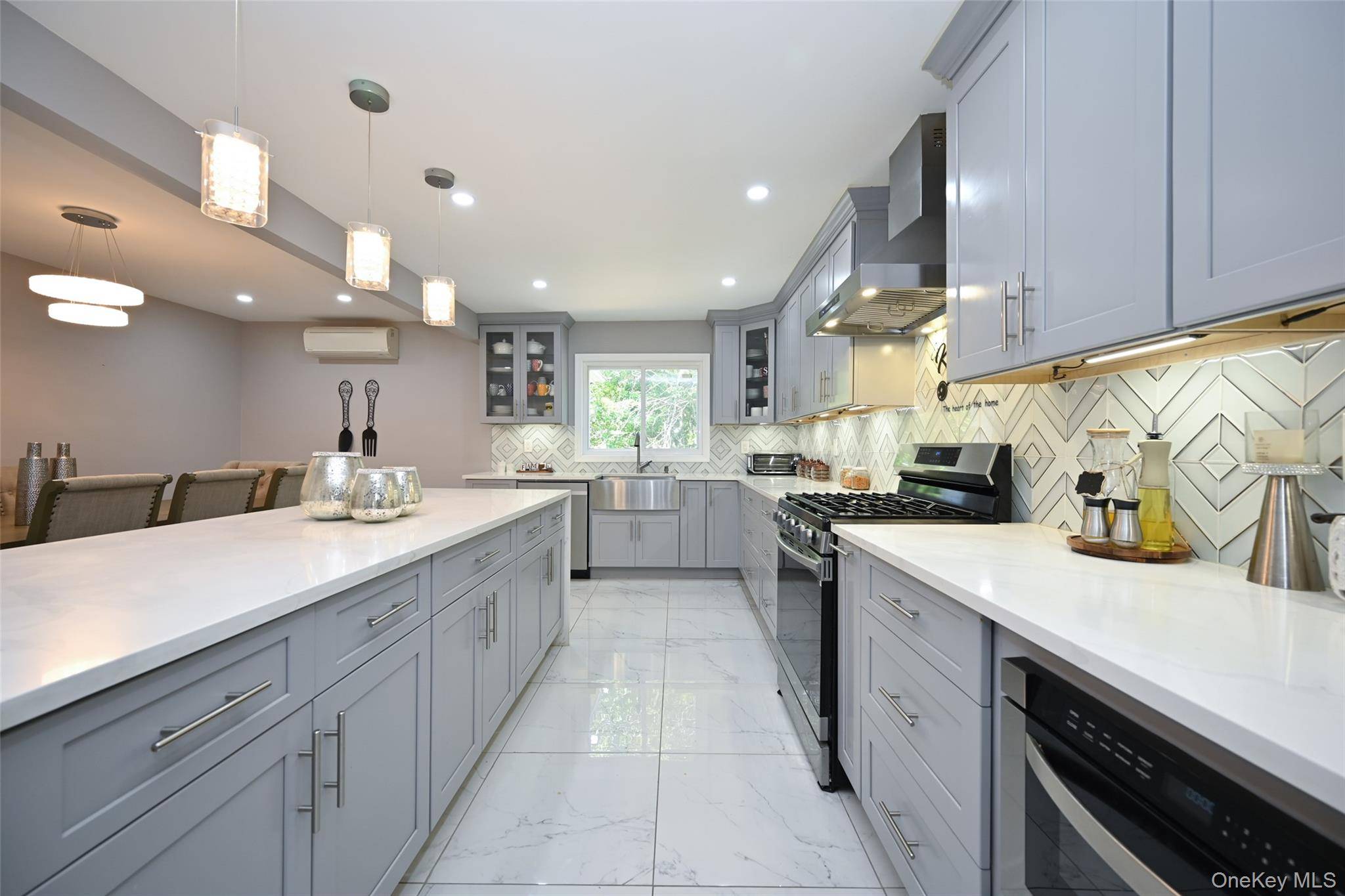 Sun drenched, oversized Hi Ranch in Woodmere ideal for extended family or true mother daughter living.