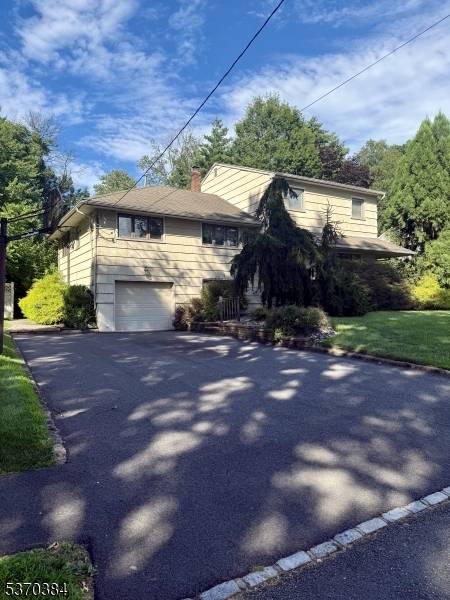 Nestled in a secluded neighborhood just beyond a quiet cul de sac, this warm and inviting 4 bedroom, 3.