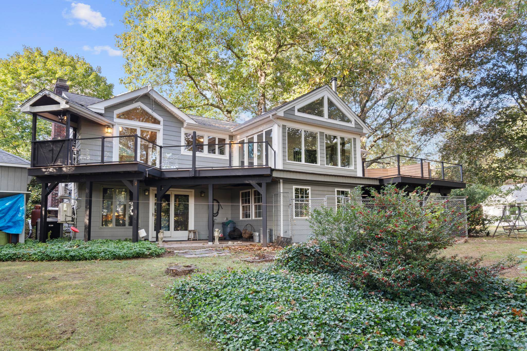 Welcome to your own retreat a lovingly renovated raised ranch on a lush, artfully landscaped lot.