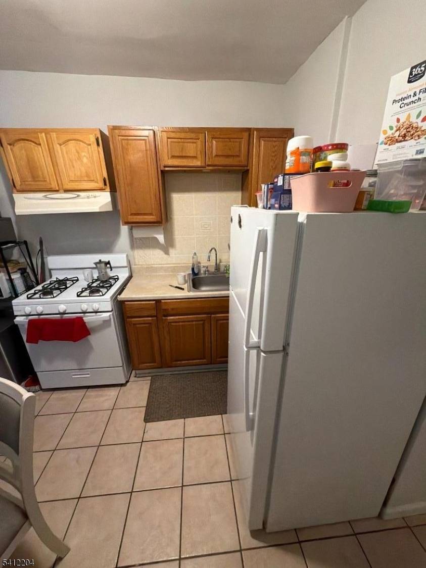 Welcome to this well maintained legal 2 family property, featuring 2 bedrooms and 2 full bathrooms on each floor offering flexible living and strong income potential.