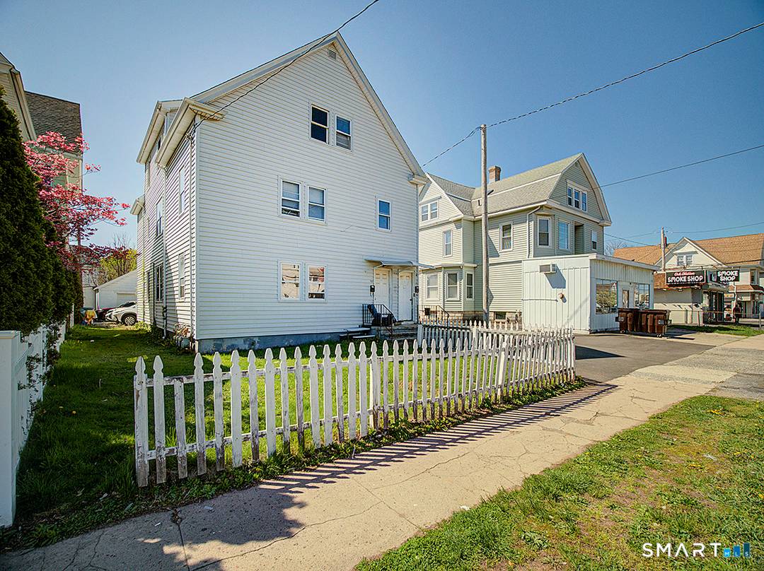 3 Family Commercial building with approximately 2000 square feet on the first floor.