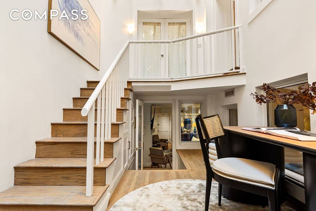 A rare and sophisticated south facing garden duplex nestled within a historic landmarked mansion on one of Manhattan s most coveted blocks just moments from Central Park.