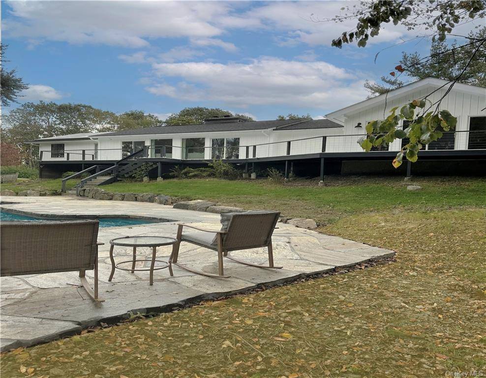 Mid century modern ranch on over three acres of rolling land on the top of Keeler Hill which is one of Northern Westchester's highest points.